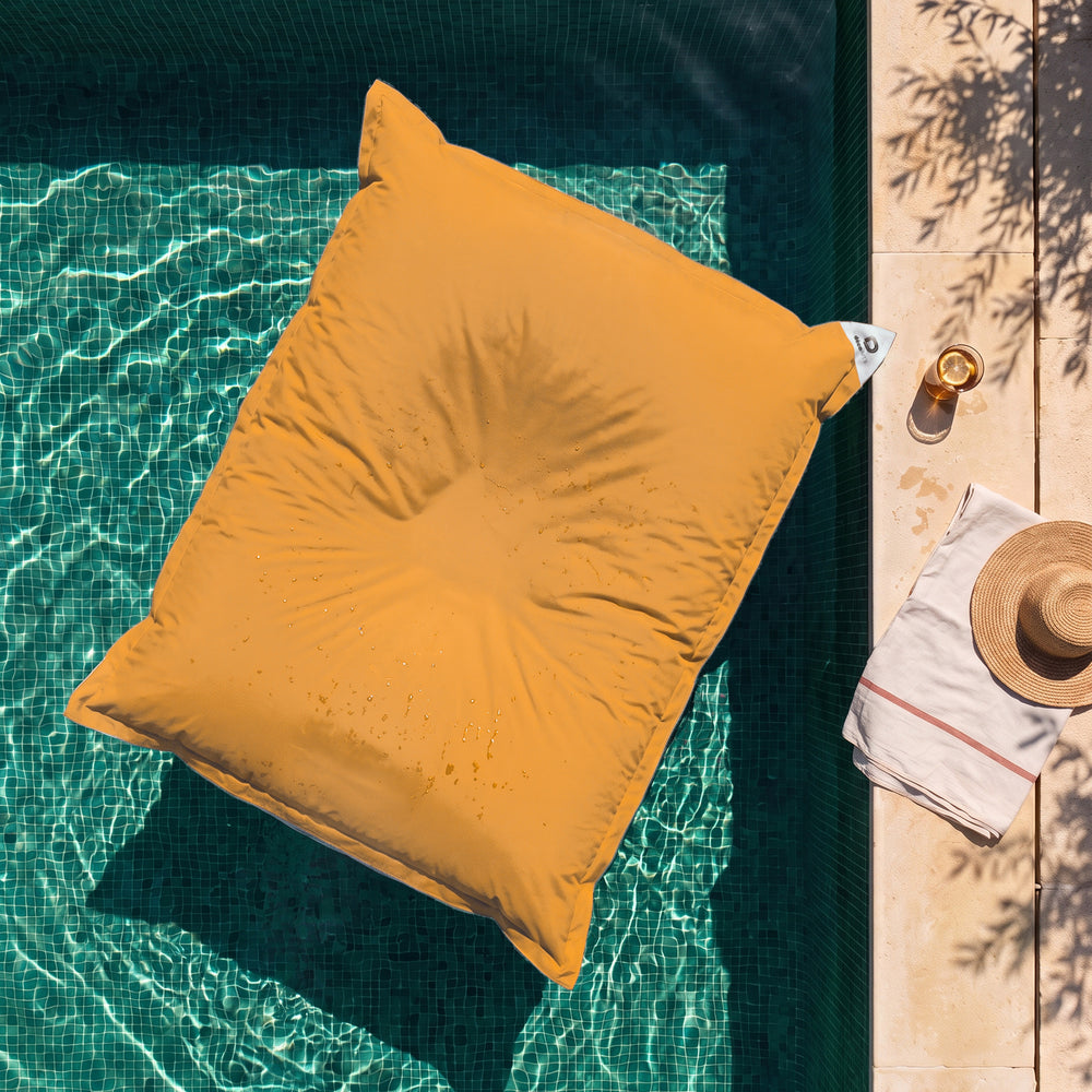 Cover only, to be filled – Honey Yellow giant floating bean bag on the water of a pool, top view